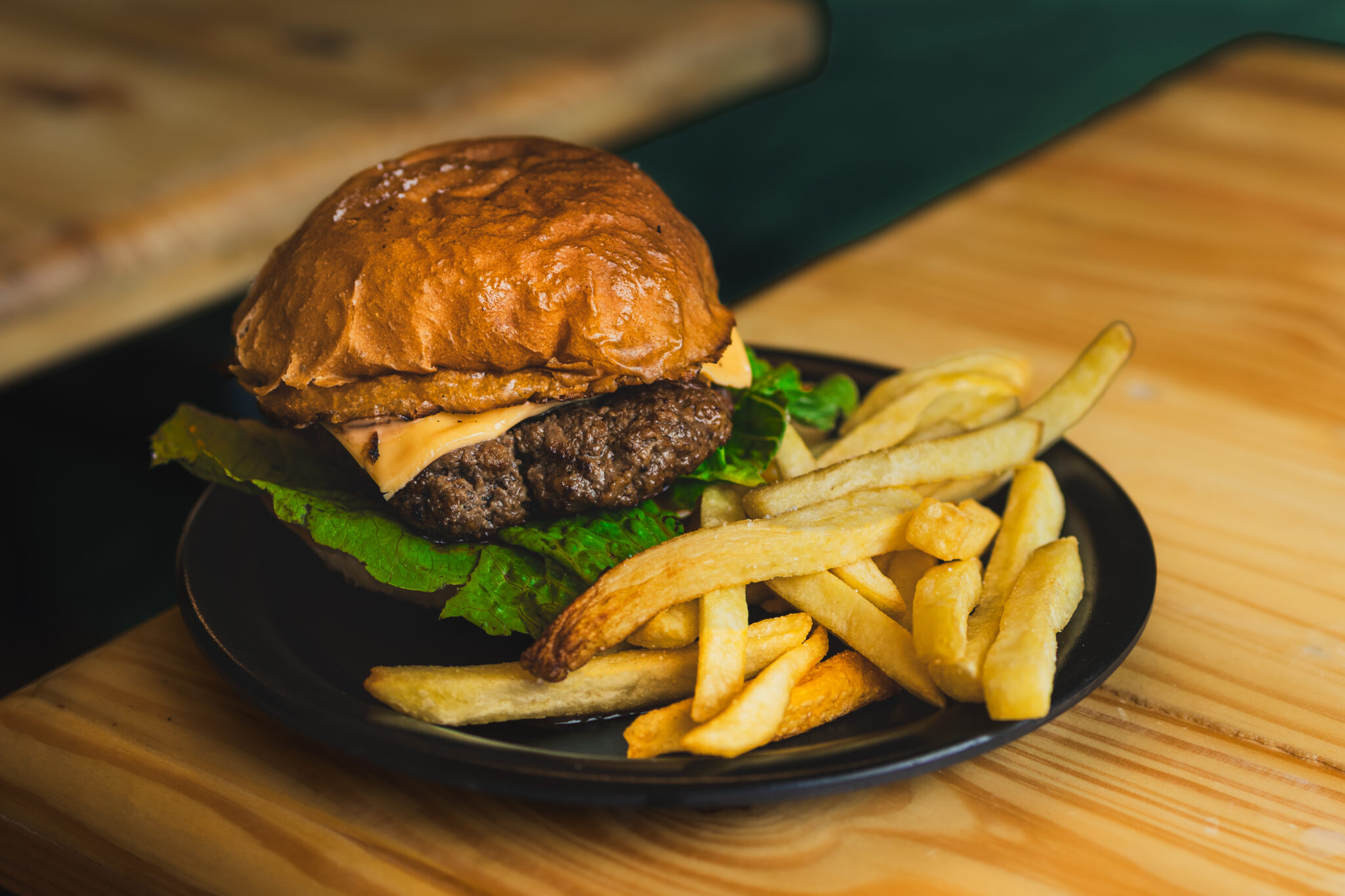 Angie's beef burger with cheese and lettuce on a fresh bun